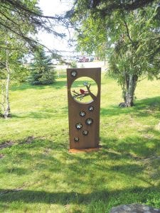 Mark and Ruthann Ohlsen of Faribault, Minnesota as a tribute to their son Quinn, who passed away last year, have donated a new piece of artwork to the Grand Marais recreational park. Called “Cherry Blossom” the piece stands near the path that leads from the Highway 61 sidewalk down into the park near North House.