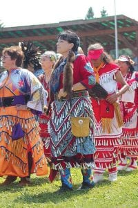 The women jingle dress dancers move in rhythm with the drums, adding to the sound of powwow.