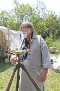 There were cartographers and surveyors and all manners of maps at Rendezvous Days. This surveyor explains the use of a theodolite to camp visitors.