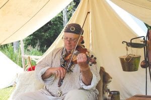 Left: Music was heard throughout the grounds day and night, thanks to reenactors like this fiddling fellow. Above: Kids had a great time at Rendezvous!