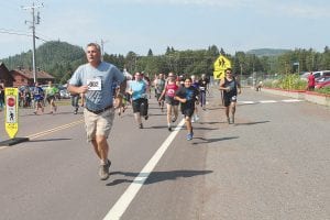 Grand Portage Health Services once again hosted the Rendezvous Days Run-Walk. Runners (pictured here) and walkers could participate in a one-mile or three-mile event. Before the race excited children chased each other around the health clinic and parents cautioned, “Save your energy for the run!” Everyone completing the run-walk received a colorful T-shirt with a design by Aurielle Housey on the front and by Sara Smith on the back. The T-shirt showed that participants went on a bimose (walk) or bibaamibatoo (ran around).