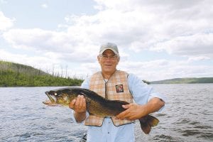 Mike Hyzer of Iowa was all smiles when he reeled in this impressive 32-inch walleye while fishing on Gunflint Lake recently. Hyzer released the big fish.