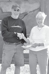 Greg Koschinska, president of the Sugarloaf: The North Shore Stewardship Association, presents the annual Tombolo Award to Margit Berg. The award recognizes an individual for outstanding service and contributions to the organization’s mission – inspiring the preservation and restoration of the North Shore. Berg has been involved with Sugarloaf for 10 years and currently serves as coordinator of volunteer services at Sugarloaf Cove where she manages over 40 volunteers providing training, coordination of site hosting, and special projects.