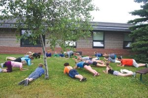 Cook County High school and middle school work on a variety of stretching and strengthening exercises before they begin their long run for cross country practice. There are 39 kids out for cross-country this year between Two Harbors and Cook County High School. The two schools have teamed up to run together as one program.