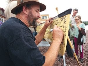 Marco Good put his signature on the Freemans' canoe. The Freemans hope to give the canoe to the president when they arrive in Washington, D.C., as a powerful symbol of their petition against sulfide-producing mining.