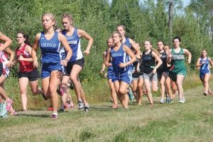 Above: Several Vikings got out fast at the start of the Viking Challenge cross country race at Pincushion Mountain Thursday, August 28. Morgan Weyrens-Welch is just ahead of Matea Acero and Melanie Stoddard can be seen at the back of the pack. Far left: Gritting it out, Jake Peron (left) and Kiviok Hight sprint for the finish with Kiviok edging Paron for 6th place. Left: Sean McDonell powered to the finish line.