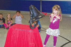 Evie Brandt, a new kindergartener at Birch Grove Community School, takes her turn in a back-toschool tradition at the Tofte school—a bell ringing ceremony. All the students had a chance to make some noise as school started.