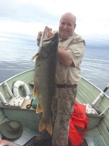 Former Cook County News-Herald staffer and local fisherman Dick Nelson periodically shares photos of fish caught aboard his boat which he has dubbed “Free Loader Charters.” This week he is sharing the story of Mike Boland, resident of Lutsen’s Caribou Lake, who had never been on Lake Superior before, nor had he caught a lake trout. He had beginner’s luck when he reeled in this massive lake trout. Nelson said the “Free Loader” skiff budget doesn’t have a ruler or scale, so the men had to guess to the big trout’s size. Nelson said it was a “two fist’r,” as in it took to fists to hold it up for the photo. Nelson said the beautiful lake trout was returned to the sea, where “it would likely win the 2015 Fisherman’s Picnic contest entry.”