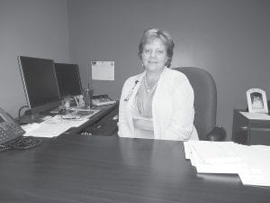 Her desk neat and tidy, Vera Schumann took a break from her very busy job as the Cook County North Shore Hospital/Care Center financial director to talk a little bit about her life before moving to Cook County. Schumann has the difficult task of wading through the never-ending changes in health care reimbursements and finances.