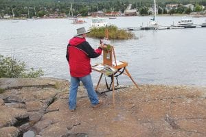 In the Quick Paint competitions, artists spread out to get different views of the beautiful Grand Marais harbor. This painter picked a spot that gave him an interesting angle of the Coast Guard Station.