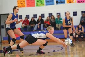 With Linden and Meredith Sutton (No. 5) looking on, Jami Sjogren makes a great play to scoop a ball off the floor in the Vikings' game against Esko. Esko beat the Vikings in 3 straight games but the Vikings rebounded to take 2-3 games in the Hill City tournament.