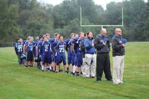 Assistant Coach Mike Boomer, Head Coach Mitch Dorr and Assistant Coach Bryan Carpenter and the Viking football team show their respect as the National Anthem is played before one of the Vikings' recent games. Although the team is 0-4 this year, they have been competitive in most of the contests. The Vikings play Ogilvie Friday, September 26 at home. The game starts at 7 p.m. Come out and cheer for your Vikings!