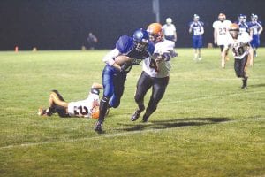 Above left: Viking wide receiver Andy Farley stiff-armed No. 4 to go for a long run after a catch against Ogilvie. Above: Wearing number 9, Richie Furlong scored the Vikings first touchdown on this carry against the Ogilvie Lions. Left: After putting his shoulder down and running through the tackler, Jack Wieben picked up a couple of extra yards by lunging forward before being brought down.