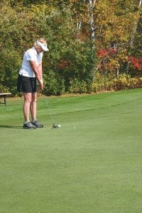 Above: Close but no cigar: Paula Sundet Wolf lined up and hit this 15-foot putt 6 inches shy of the hole in the North Shore Health Care Foundation golf tournament.