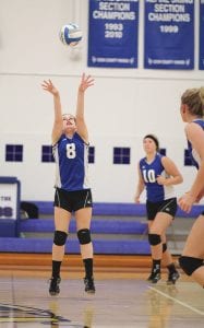 In the Vikings’ game against South Ridge Alex Slanga (8) set a ball to Britta Andress in the front row while Lily Gruber-Schulz (10) looked on.