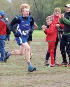 Above: With his mother cheering him on Andy Kern ( No. 371) sprints to the finish line at the Swain Cross Country meet held at Enger Golf Course in Duluth on October 4.