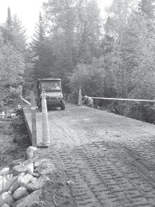 The Minnesota Department of Natural Resources (DNR) has made great improvements to the 16-mile Hovland Woods grant-in-aid allterrain vehicle (ATV) trail. The DNR recently completed installation of two bridges along the trail across Swamp River. Dick Tesch and Warren Glenna were the first ATVers to cross the new bridges that will protect the quality of the nearby pond. The grant-in-aid trail is maintained by the Cook County ATV Club.