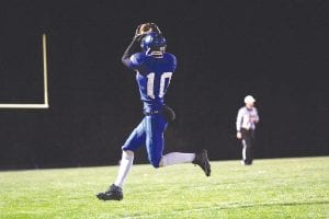 Left: Owen Anderson caught nine balls for 204 yards to set a new CCHS record by a Viking receiver in the game against Mesabi East held Friday, October 10. Above: Will Lamb (7) tries to get his arms around the Mesabi East ball carrier while Travis Bradley (26) and Jamie Wick close in fast to assist on the tackle.