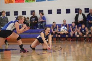 Above: Linden Sutton went to her knees to save this spike in the Vikings’ recent game against South Ridge while Jami Sjogren got ready to assist on the play. Left: Playing on the back row, Meredith Sutton made a valiant attempt to make a play on a tough serve.