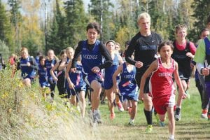 Left: Will Ramberg works through a field of runners in the Polar League Conference meet held at Pincushion Mountains. Also spotted just behind Ramberg are Sophie Eliasen, Robin Henrickson, Amelia Roth, and Chloe Blackburn. Above left: Maya McHugh is back from a long injury and picking up her fitness. Above right: David Blackburn ran a strong race, finishing with a 5K time of 23:16.