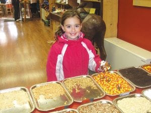 The Gunflint Mercantile was once again a busy place during Moose Madness as Chelsea Pusc offered cookie and caramel apple decorating. Little Sofia was one of the dozens of kids who enjoyed creating her own apple masterpiece.