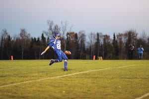 Above: The Vikings' punter, Andrew Lashinski, sent the ball skyward against Barnum. Right: Senior tight end Travis Bradley made a fine catch against Barnum.