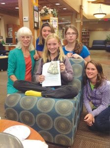 The Grand Marais Library had 91 kids taking part in its “Paws to Read” summer reading program. In addition to reading, the celebration featured a number of contests. There was also a book review contest. Winning first place was Robin Henrikson (center). She won $150.