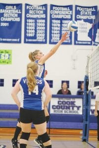 Rising above the net, the Vikings' strong middle hitter Britta Andress powered the ball back against Wrenshall in the Vikings' first playoff game.