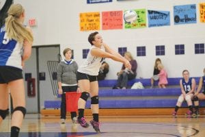 Up on her tippy toes, the Vikings' libero Carrie Palmer bumped the ball to her frontline in a recent game.