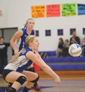 Jamie Sjogren looks on as Morgan Mixdorf goes low to make a play on a hard hit ball.