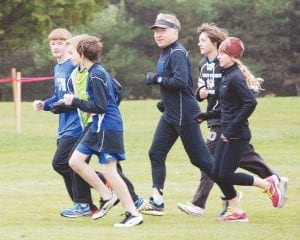 Assistant cross country coaches Chris Hegg and Mandy Dye put in a few miles with Viking runners. Hegg smiles for the camera as he jogs by.