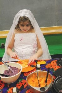 A spooky bride spent some time in the cookie decorating area at the October 26 carnival.