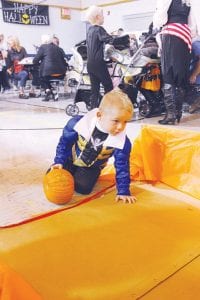 A new activity at the Birch Grove Carnival this year was pumpkin bowling. Little Trygve lines up his shot to take down the ghost bowling pins.