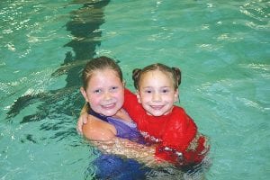 Taylor Everson (left) and Libby Magnone give each other a big hug after their exciting championship match in the U-7 age group national championship match. Libby won 3 falls to 1.