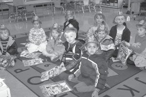 During Fire Prevention Week in October, local fire departments visit local schools. The West End Fire and Rescue squad made its annual visit to Birch Grove Community School that week. Above: The Birch Grove kindergarten/ first grade class show off their firefighter hats. Right: Arlo Christensen visits with Tofte Emergency Medical Services Chief Louise Trachta during one of her last official duties before retiring as EMS chief.