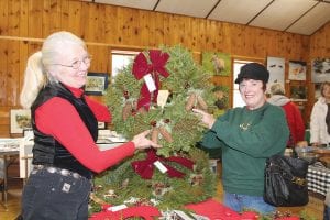 Christmas is coming! It’s time to make the rounds of the wonderful local sales and shows to find that perfect gift. Marcia Lacey found the perfect wreath made by Dianne Pelto (left) at the Hovland Artisan’s Christmas Sale last year.