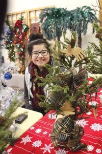 Whitney Wahlers looked festive at the Crafts and Vendor Christmas Market. She helped her grandmother, Diane Hagen, sell some beautifully decorated Christmas trees, including a cheerily lit palm tree.