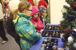 These kids were impressed by the amazing variety of glass-blown Christmas bulbs made by Tom Crosby.