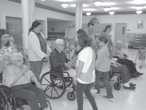 There was live music and square dancing going on at the Care Center the day before Thanksgiving. Girl Scout Troop #4070 joined in the fun to learn the Virginia Reel. Florence and George Bloomquist led everyone while the Flute Reed Ramblers performed some real toe tapping tunes.