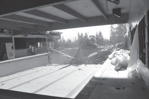 A last look at the inside of the Grand Marais Municipal Pool. Former members of the Grand Marais pool have been watching with some sadness as the pool goes down. Nelson Machine Products has been trucking the waste to Canyon, Minnesota because 3 percent of the glue in the building has asbestos in it and the waste must be disposed in a facility that can handle the cancer-causing agent. Nelson is using a trailer that holds 49 yards of waste.