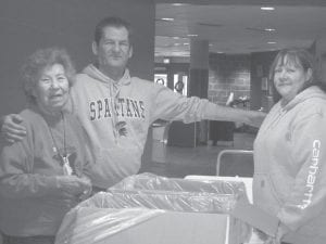 Elders had fun making goodie bags to be given to the Oshki Ogimaag kids at the children’s Christmas concert and program. From left, Ellen Olson, Tim Anderson and Ellie Altman bagged candy.