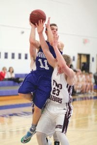 With his eyes on the basket, Rory Bakke slid by the Two Harbors' defender to score 2 of his 12 points against the Agates in a game the Vikings lost 49-14.