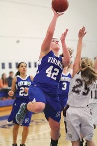 With Molly Thomas looking on, Vikings’ center Emily Jacobsen went strong to the basket to score 2 of her team-leading 9 points against Two Harbors.