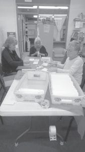 Volunteers helped send out New Year’s greetings. (L-R) Julie Rannetsberger, Ginny Cooley, Nancy Koloski.