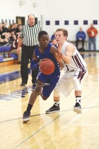 Sam O’Phelan (inset) drove hard around his Two Harbors defender while Jamie Wick (35) took a deep shot from the corner against the Agates in a contest the Vikings lost.