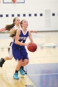 Sarah Toftey took aim at the basket in a recent home game against the Two Harbors Agates while No. 10 Lily Gruber-Schulz went up and scored 2 of her 9 points in that contest. Lily also ended up with 9 rebounds in the December 11 game. The Vikings played and lost three times to the Agates in a two-week period.