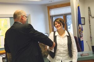 Judge Cuzzo congratulates County Attorney Molly Hicken after administering the oath of office. Cuzzo has been working with Hicken since he started serving Cook County. Hicken has been acting county attorney since October 2013.