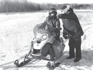 Students completed field testing for Minnesota Department of Natural Resources (DNR) snowmobile safety in December. DNR Conservation Officer Mary Manning directs a student through the course.