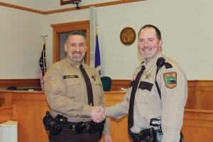 Cook County Sheriff Pat Eliasen (left) congratulates Chief Deputy Will Sandstrom after the men took the oath of office on Friday, January 2, 2015. Judge Michael Cuzzo administered the oath as friends and family looked on. Judge Cuzzo said administering the oath of office to fellow public servants is one of his most pleasant tasks as judge. With little fanfare, the Sheriff and Chief Deputy visited with the public for a few minutes and then headed back to work.