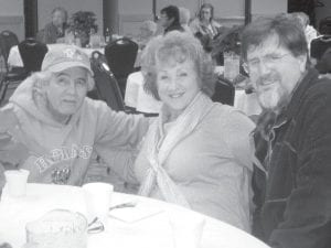 Dido Swader, the ENP advisory board chairman, visits with Brandy and Scot Frazer at the Elder Christmas party. Brandy is Corky Stevens' daughter.